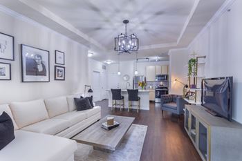 A modern living room with a white sofa and a coffee table.